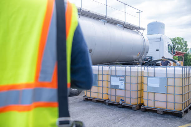 istock An engineer accepts a tanker vehicle with lubricants and controls the transfer into a 1000-liter IBC bulk container. 2172624946