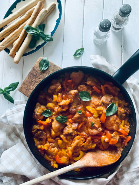 istock Chicken nuggets with peppers and tomato sauce. 2172626329