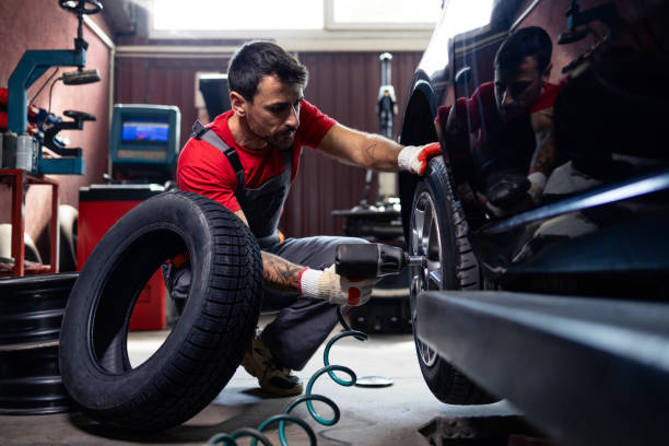 istock Replacing damaged car tire in workshop. 2172634882