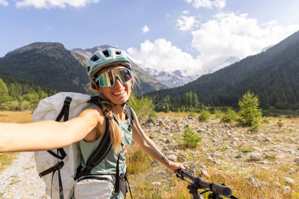 istock Smiling Cyclist Taking a Selfie in Scenic Mountain Landscape 2172635910