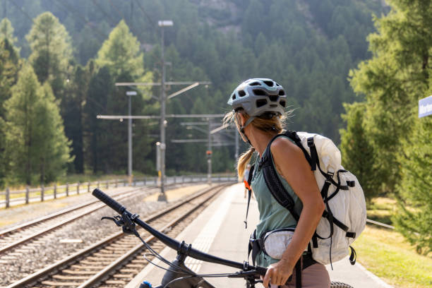 istock Cyclist Waiting at Train Station in Mountainous Area 2172636183