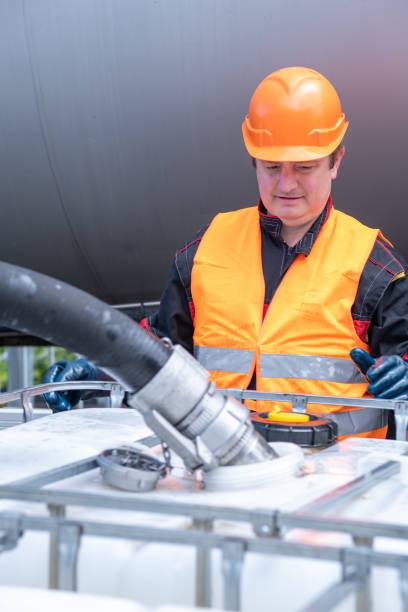 istock A technician transfers oil from a tanker into a 1000-liter IBC Bulk Container. 2172636879