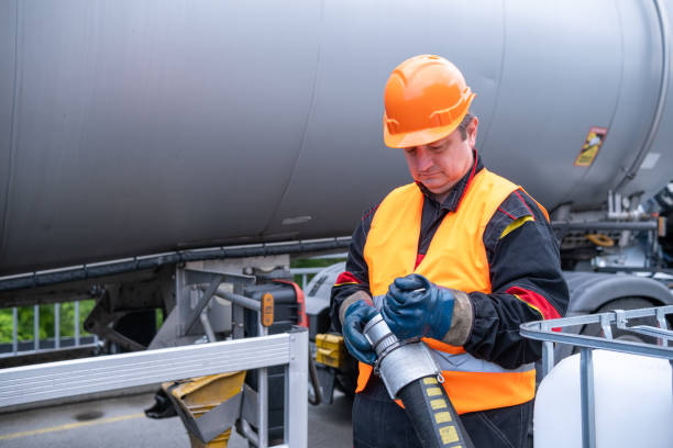 istock A technician holds a pipe in front of a lubricant tank. 2172636961