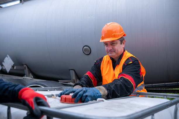 istock A technician opens the lid of a 1000-liter IBC bulk container. 2172637040