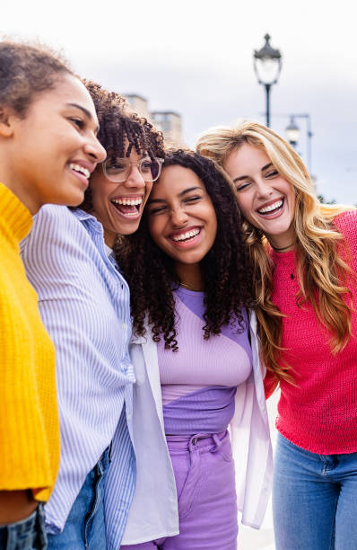 istock Diverse group of young women laughing together while hugging each other outside 2172637364