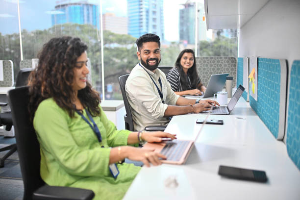 istock Engaged colleagues discussing while enjoying work in a modern Indian office 2172638905