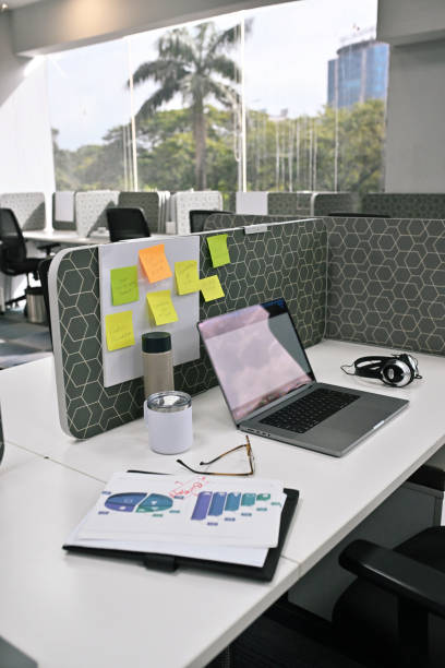 istock Office Desks with Open Laptop and colourful post-its lit by beautiful natural sunlight 2172639248