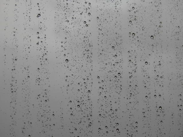 Drops of rain water falling down the window panes after the rain