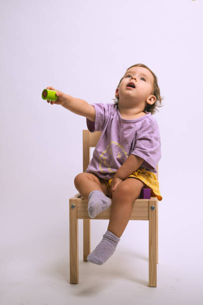 istock girl playing in studio session with white background 2172640495
