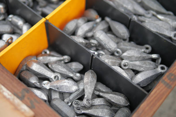 A variety of assorted fishing weights neatly organized and placed in a storage box