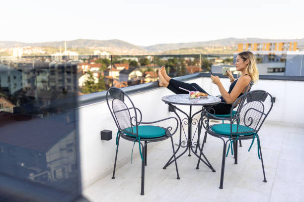 istock Woman enjoying a cup of tea on balcony 2172643780