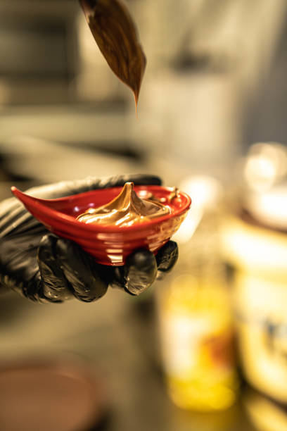 istock The chef pours chocolate cream into a bowl preparing plate for Churro 2172644221