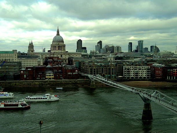London, England - Aril 1, 2012: The River Thames with ships and boats and the city of london with St. Paul's Cathedral and buildings