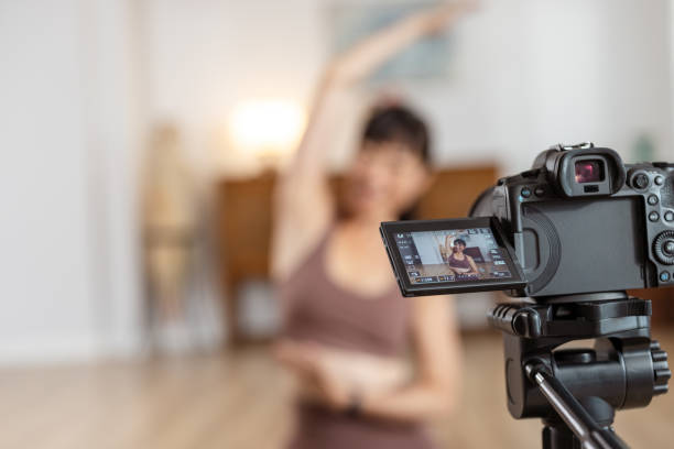 istock Yoga instructor recording class in apartment 2172647033
