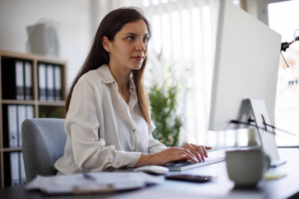istock Smiling young business woman working at office 2172648128