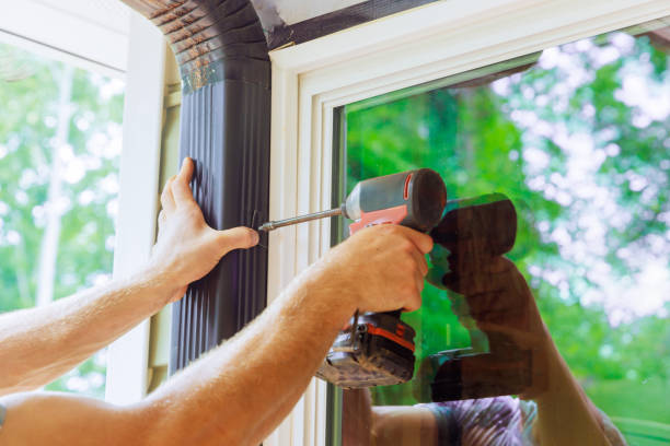 istock Handyman is assembling gutter channel that is attached to roof with a installation of gutter 2172651976