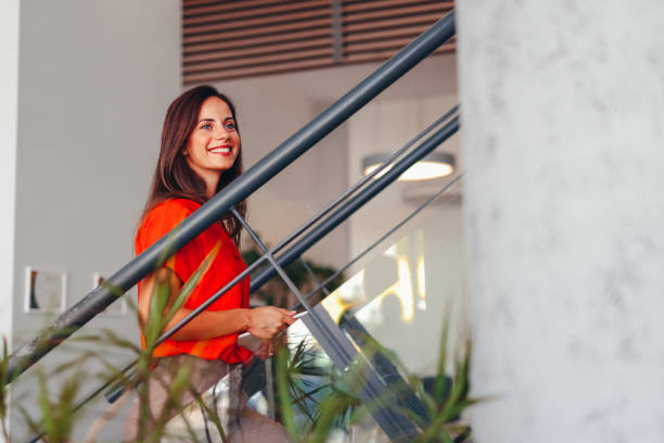 istock Young happy businesswoman using touchpad while working in the office 2172654356