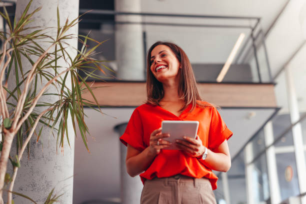 istock Young happy businesswoman using touchpad while working in the office 2172654367