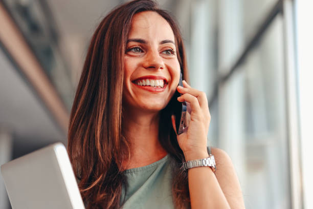 istock Smiling businesswoman using phone in office 2172654372
