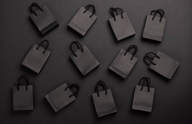 istock Pattern of shopping bags on black background, black Friday concept. 2172658948