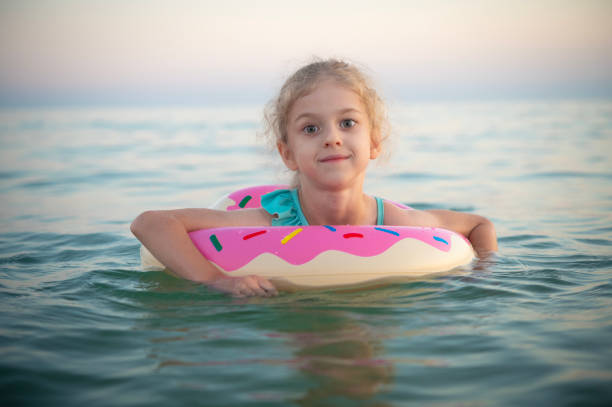 Happy little girl in inflatable disc