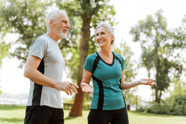 istock Senior couple wearing sportswear having fun while training together outdoors in park 2172667700