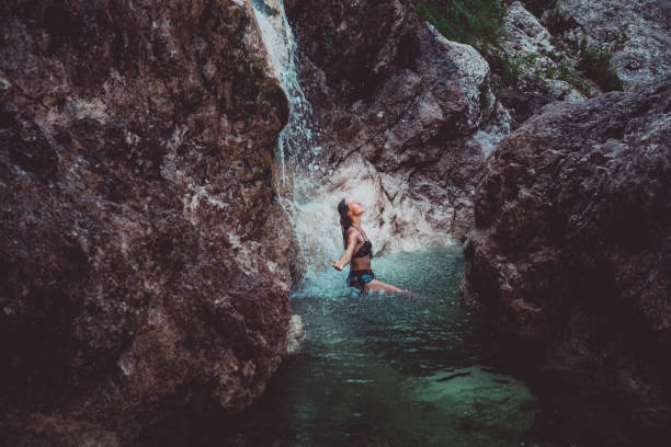 istock Young woman enjoys waterfall in Soca Valley 2172667705