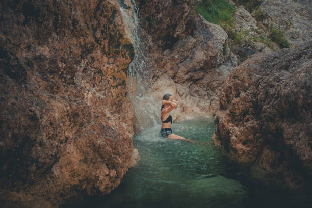 istock Young woman enjoys waterfall in Soca Valley 2172667706
