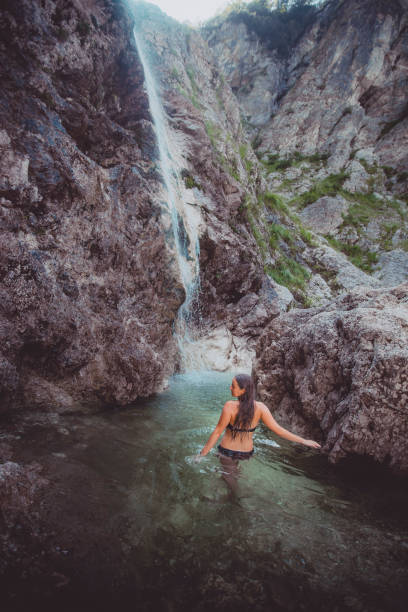 istock Young woman enjoys waterfall in Soca Valley 2172667805