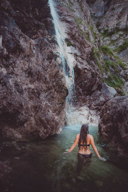 istock Young woman enjoys waterfall in Soca Valley 2172667808