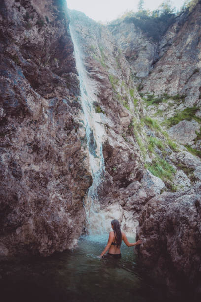 istock Young woman enjoys waterfall in Soca Valley 2172667834
