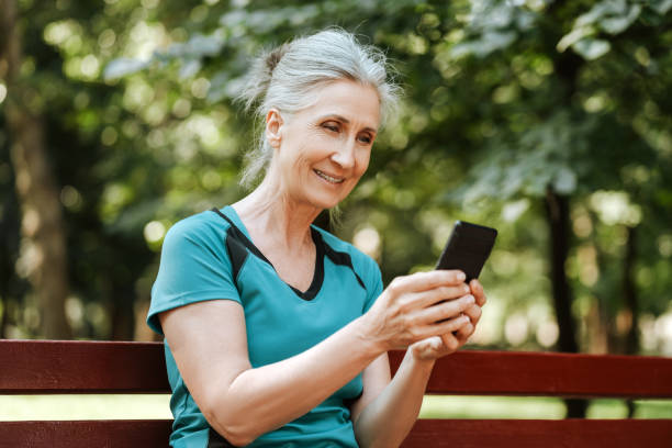 istock Happy senior woman using her smartphone while relaxing on bench after outdoor workout 2172667887