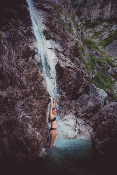 istock Young woman enjoys waterfall in Soca Valley 2172667888