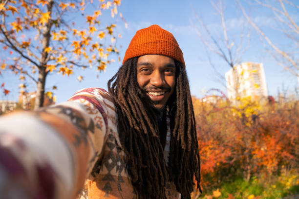 istock selfie of young black guy with dreadlocks wearing orange hat 2172668052