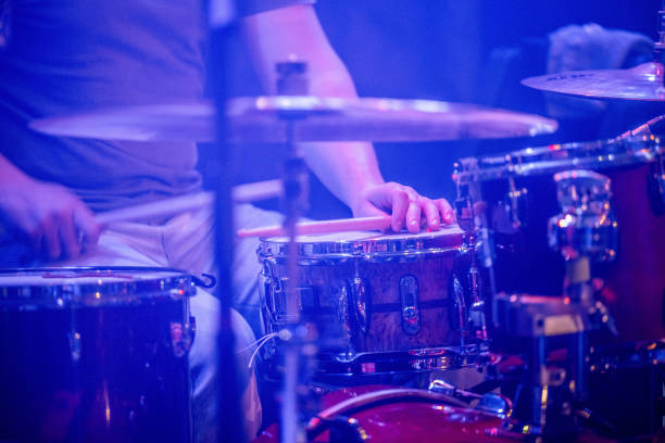 Drummer live on stage behind the drums