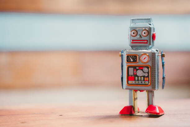 istock A vintage robot toy with a silver body, red feet, and a surprised expression on its face. 2172674334