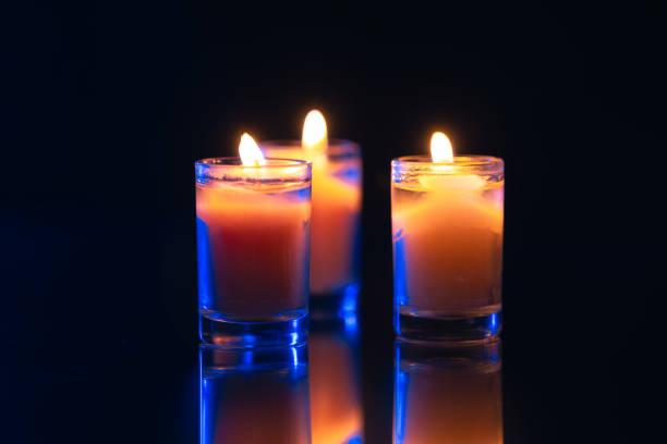 Burning candle on black background with backlight. . Memorial Day. High quality photo