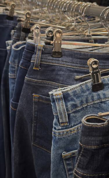 istock Denim jeans hanging on racks during a recycling event at a community center 2172675894