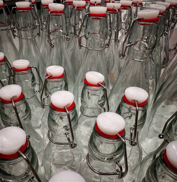 istock Glass bottles with red caps arranged neatly on a table in a store 2172676202