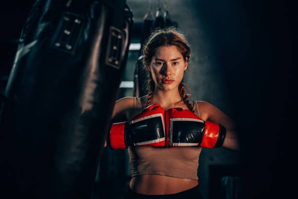 istock Powerful boxer focuses intensely at punching bag 2172676542