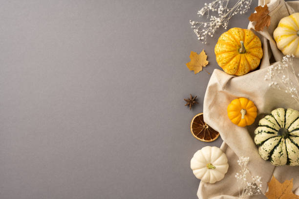 istock Seasonal autumn composition featuring small pumpkins, dry leaves, and rustic fabric creating a cozy harvest atmosphere 2172678383