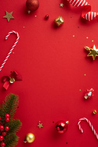 istock Bright and cheerful Christmas vertical scene featuring ornaments, candy canes, and festive decorations on a red background 2172678548