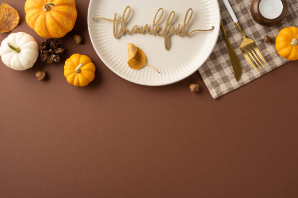 istock Autumn Thanksgiving table setting featuring small pumpkins, a thankful message on a plate, and seasonal decor. Perfect for holiday gatherings and expressing gratitude with family and friends 2172678681
