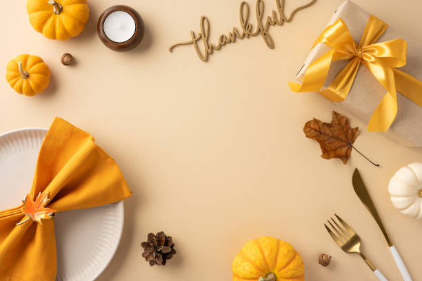 istock Elegant Thanksgiving table setting featuring decorative pumpkins, autumn leaves, and a beautifully wrapped gift box. Ideal for seasonal celebrations and festive gatherings 2172678687