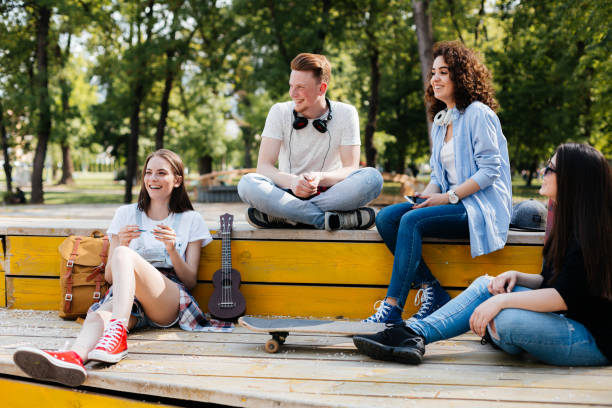 istock Teenagers hanging out in park 2172686505