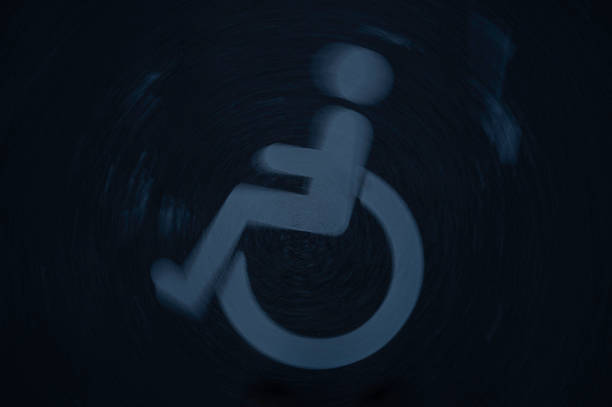 blurred wheelchair symbol on a dark asphalt, twisting around its own axis, Denmark, September 16, 2024