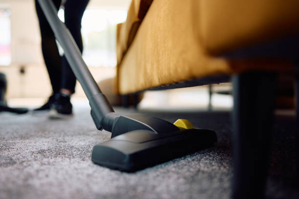 istock Close up of cleaning lady vacuuming under the sofa. 2172691069