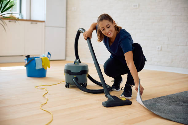 istock Happy woman vacuuming while working as professional housekeeper. 2172691136