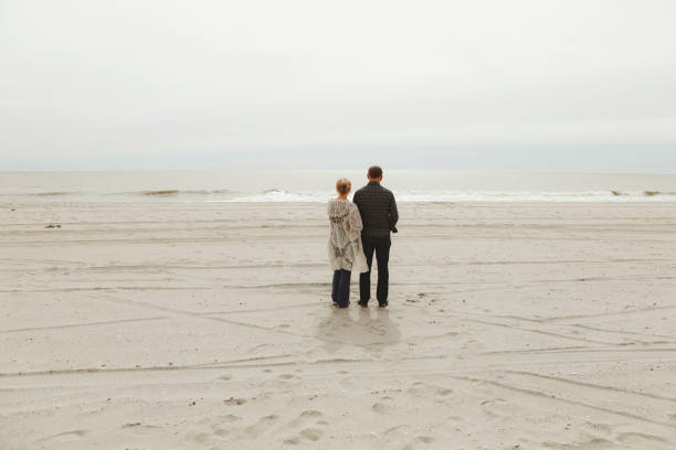 A married couple, in their early 50s, at Myrtle Beach, South Carolina, looking out over the ocean.