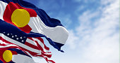 colorado-and-us-flags-waving-in-the-wind-on-a-clear-day.jpg?b=1&s=170x170&k=20&c=dIlqbjfBAuU3rEw7QLlgGANB3urmysdQU1jLDKUBj7w=